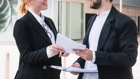 businessman businesswoman holding documents hands 1