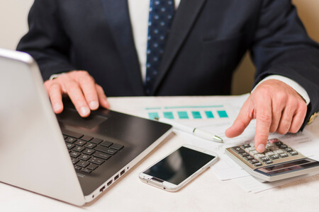 businessman using calculator 1