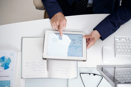 top view office desktop with notebook documents computer digital tablet used by anonymous man 1